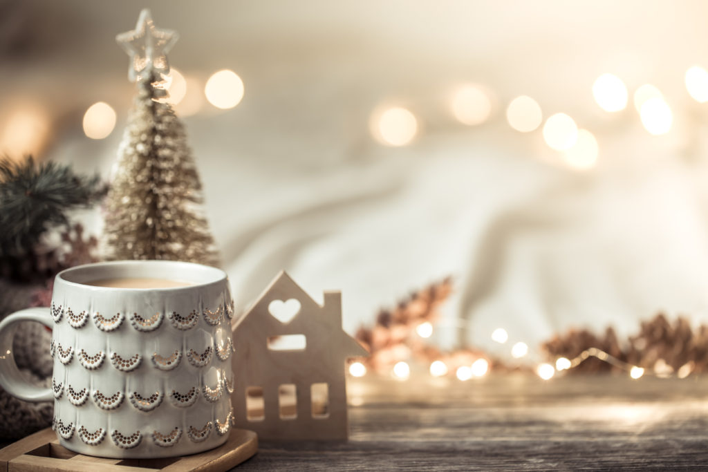 Festive background with Cup on wooden background with lights.